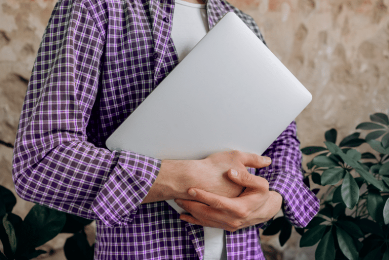 Retail Personalplanung. Das Bild zeigt eine Person, die einen Laptop hält.