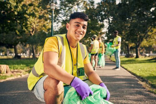 Young student cleaning the street