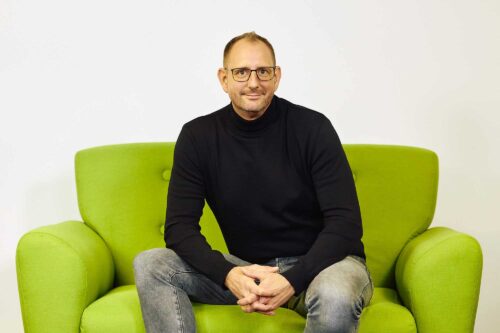 Oliver Klein, Leitung Inbound bei KiM, sitzt auf einer Couch