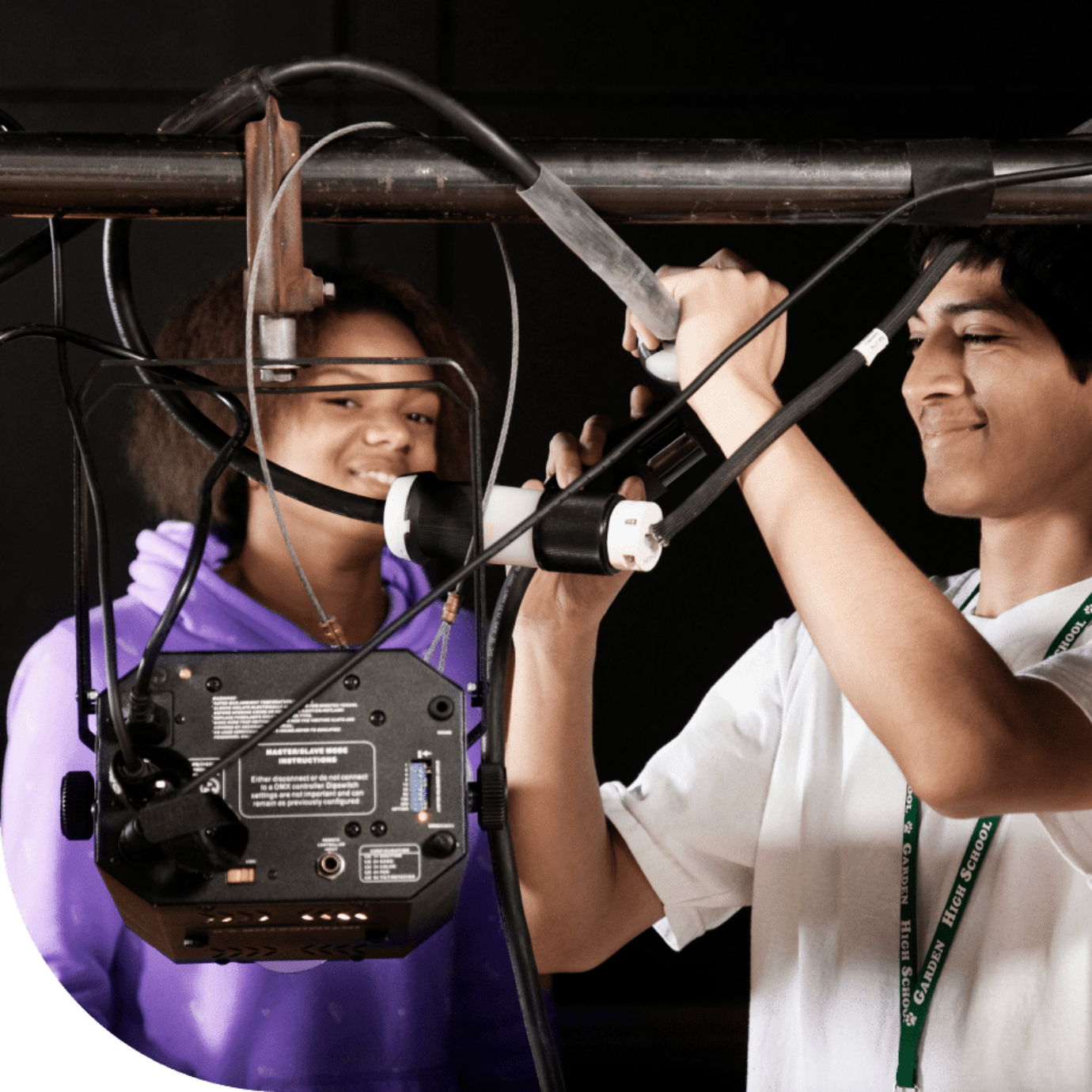 In our summer jobs, you can work as a stagehand at festivals and concerts. The image shows a young man and woman working backstage.