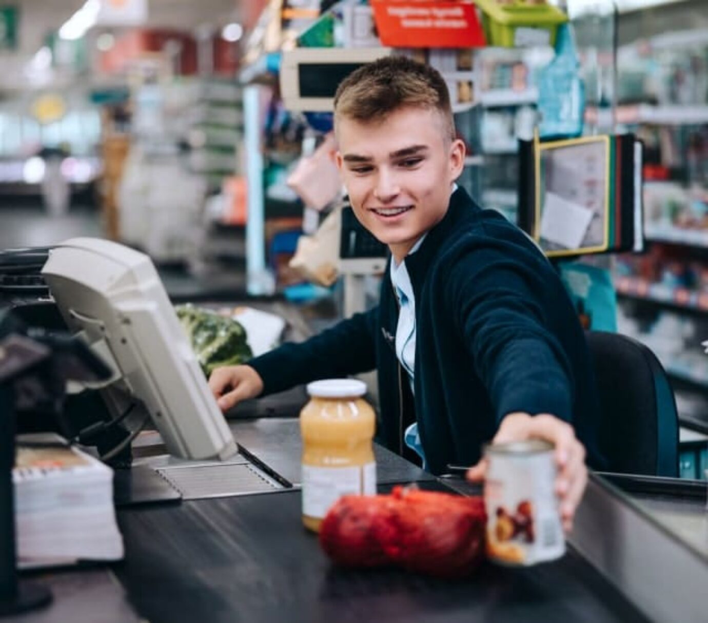 A student working as a cashier grabbing products