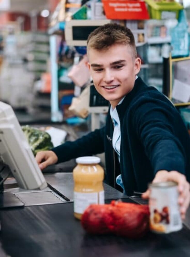 A student working as a cashier grabbing products