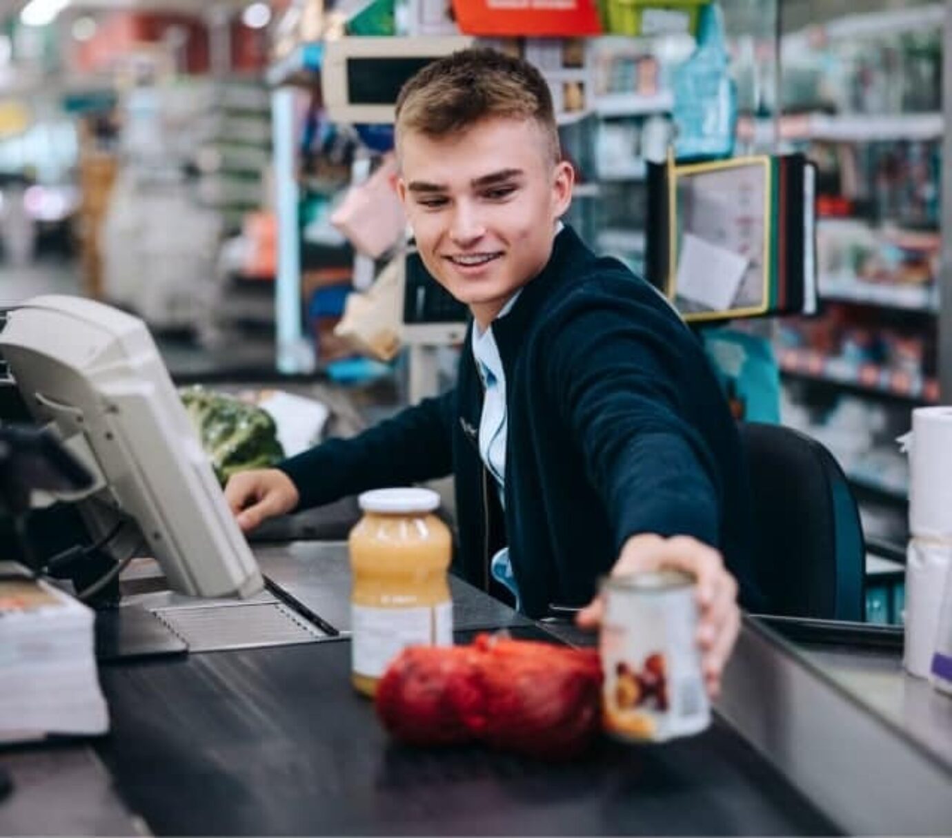 A student working as a cashier grabbing products