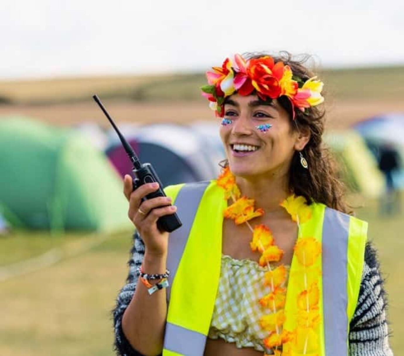 A temporary worker at the festival speaks into a walkie-talkie on the festival grounds